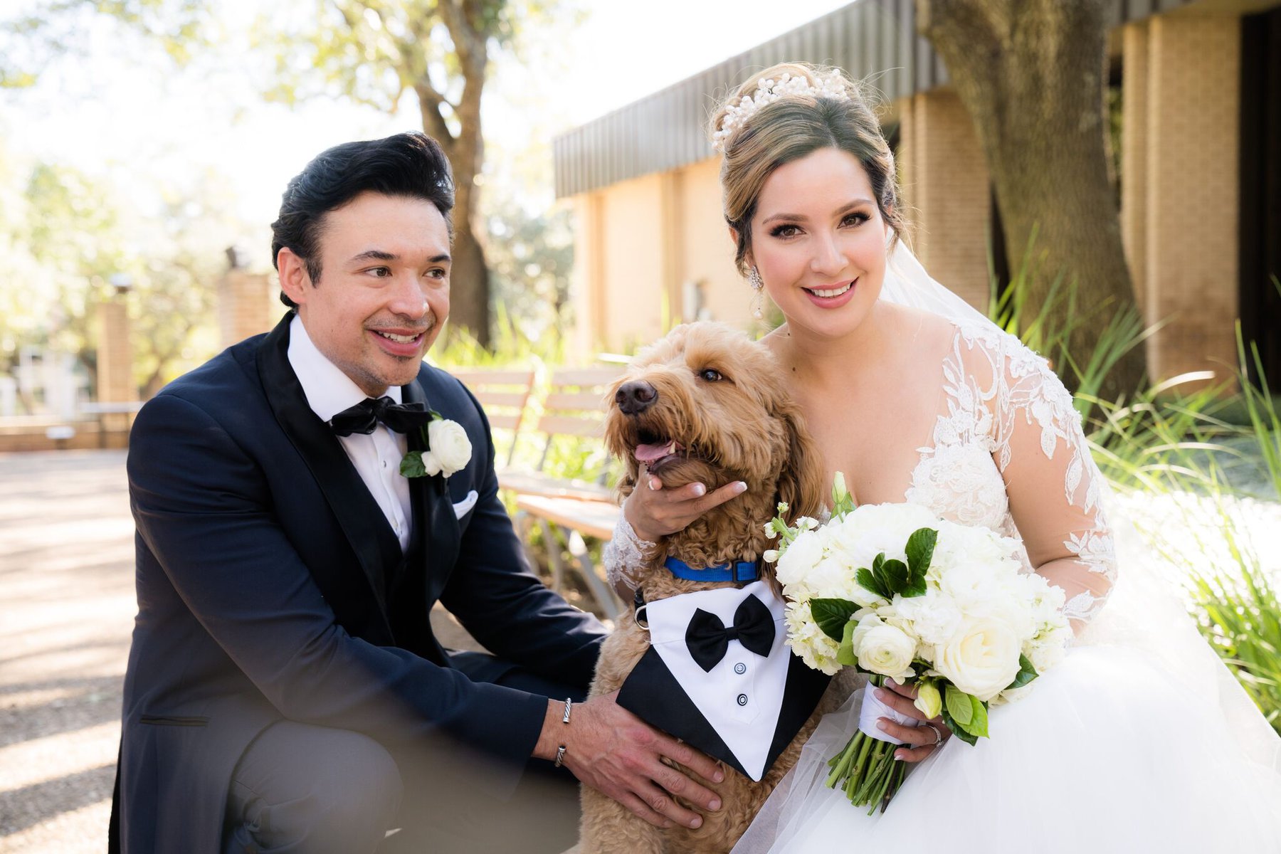 Bride and groom taking a picture with their golden doodle dog on their wedding day. Dog friendly wedding venues in Dallas and Fort Worth Texas. Plus, some Austin and other Texas wedding venues that allow pets on site.